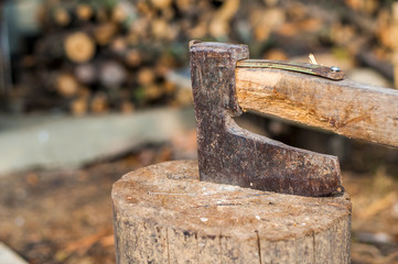 chopping wood with ax. Ax stuck in a log of wood