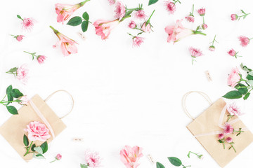 Flowers composition. Gift and pink flowers on white background. Flat lay, top view