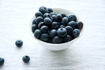 Fresh blueberries in a bowl on whote table