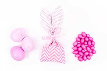 Bunny treat bag with candy and pink eggs. Easter concept
