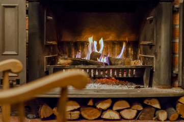 Home comfort. Rocking chair near the fireplace. Photo of interior