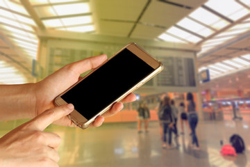 woman hand hold and touch screen smart phone, tablet,cell phone over airport terminal blur background