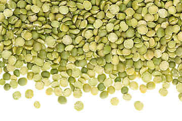 Border of green dry purified peas closeup with copy space on white background. Isolated. Healthy protein food.
