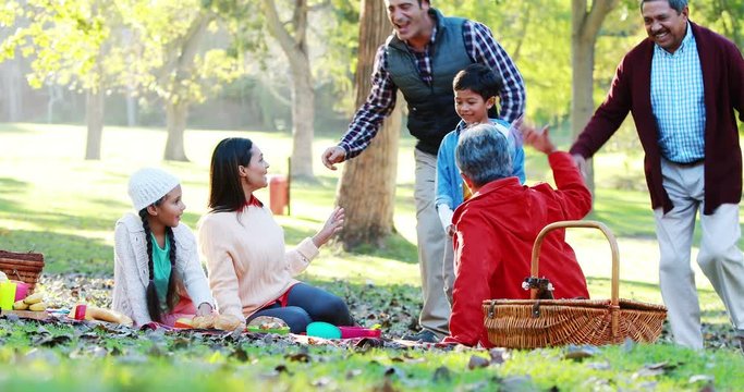 Happy family having picnic in the park 4k