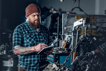 Bearded mechanics male inspecting car.