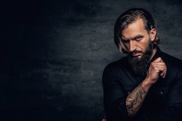 A man with tattooed arm wearing black shirt.