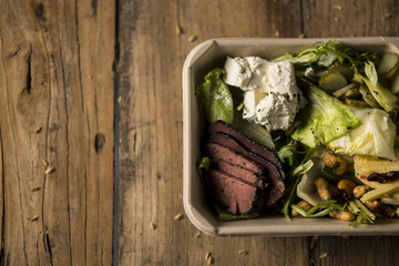 Salad shot from side on rustic wood table