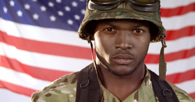 Portrait of military soldier standing against US flag background 4k