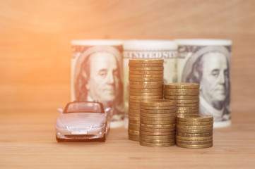 buying car dollar coins stack money on wooden background