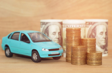 buying car dollar coins stack money on wooden background