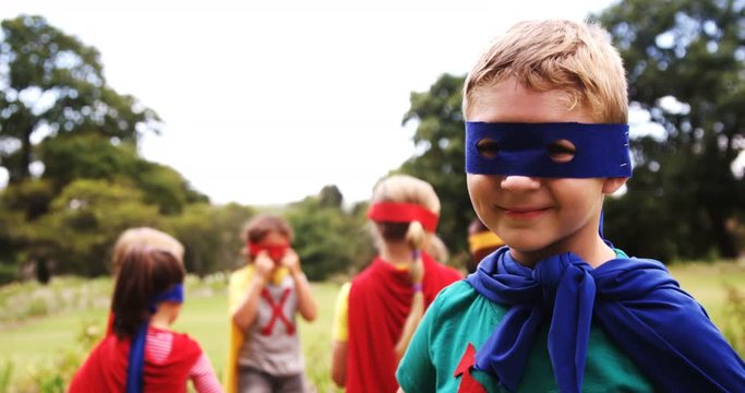 Group of kids pretending to be a super hero in the park 4k