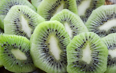 bright green background of slices of kiwi, cut kiwi, juicy pulp kiwi, green