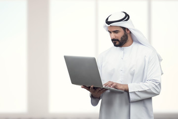 Arabian Business man using notebook in a modern office..