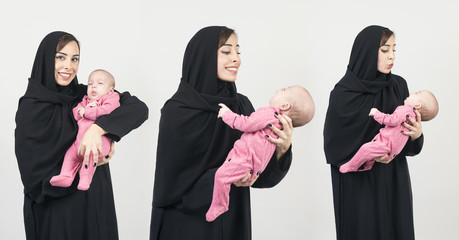 Young Arabian mother holding her little baby