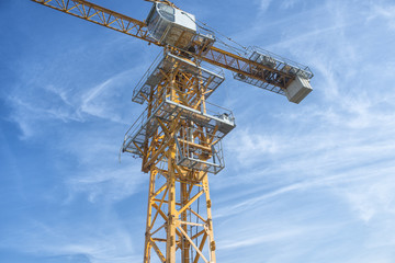 Tower crane shot against a blue sky..