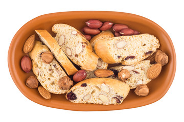 Cookies with raisins and nuts in a ceramic plate. Isolated on wh