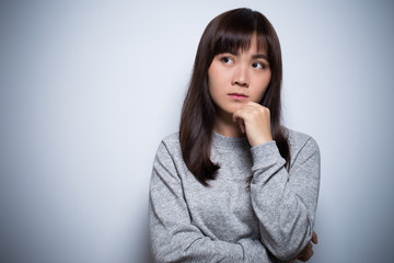 Thoughtful woman on isolated background