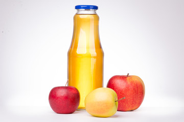 Three apples and a bottle of apple juice on white background