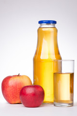 Two apples and a bottle of apple juice on white background