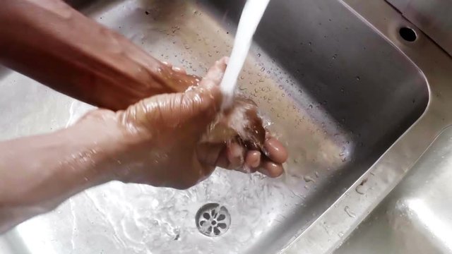 Chef washing his hands in kitchen