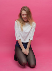 girl in black tights dancing on a pink background