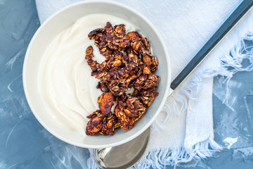 Chocolate muesli with yoghurt. Love for a healthy desserts concept.