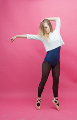 girl in black tights dancing on a pink background