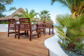 Fototapeta premium Beach with wooden umbrellas and sunbeds