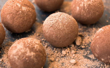 Fototapeta na wymiar Fresh truffles with chocolate, cream and cocoa