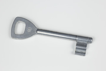Silver metallic home key isolated over white background close up in studio.