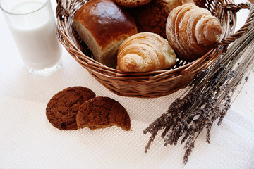 delicious fresh bread rolls in a wicker basket on the table