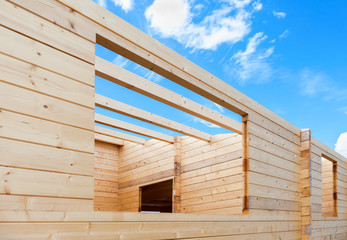 Construction of a new wooden house against the blue sky backgrou