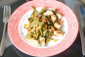 Chicken meat and vegetables on plate