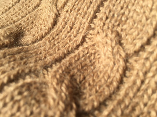 Beautiful crafted light brown wool knitted background, natural soft surface