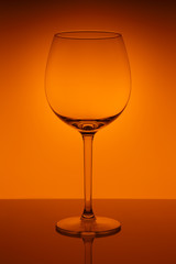 Wine glass on orange background