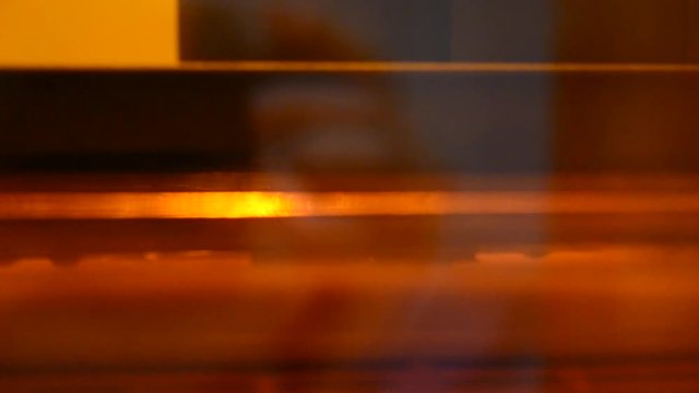Stereolithography 3d printer creation detail of photopolymer close-up. Small elements overhanging sink in liquid material and harden under UV light. Modern additive technology of photopolymerization