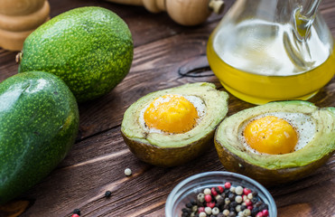 Avocado baked with egg, pepper and salt