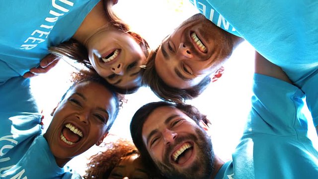 Group of volunteers forming huddles
