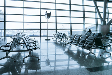 empty airport terminal waiting area with chairs