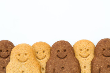 Rows of black and white, happy and smiling gingerbread men on a white background representing racial diversity and equality.