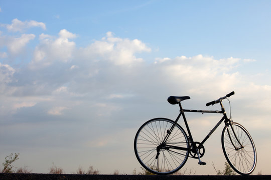 landscape of vintage bicycle against blue sky.