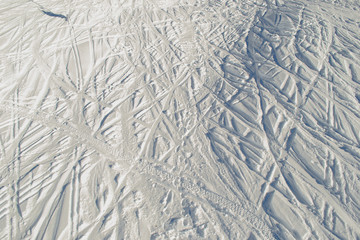 Lots ski traces at skiing resort. Snow texture. Extreme sport. Active lifestyle. Background with copy space.