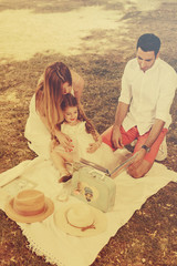 Father and mother reading book with daughter