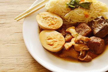 thin rice noodle with pork entrails and tofu topping egg on plate