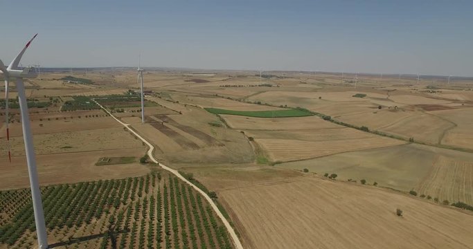 Aerial video shooting with drone on Italy wind turbine, large expanse of land that is home to a wind farm