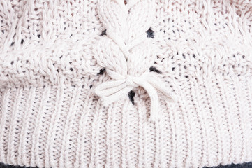 Close-up of feminine white wool sweater with pretty details