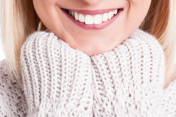 Close-up of beautiful blonde girl smile wearing sweater
