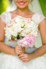 bride hands holding beautiful wedding bouquet