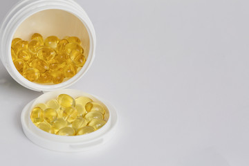 Soft gels pills with Omega-3 oil of pill bottle close-up on a white background
