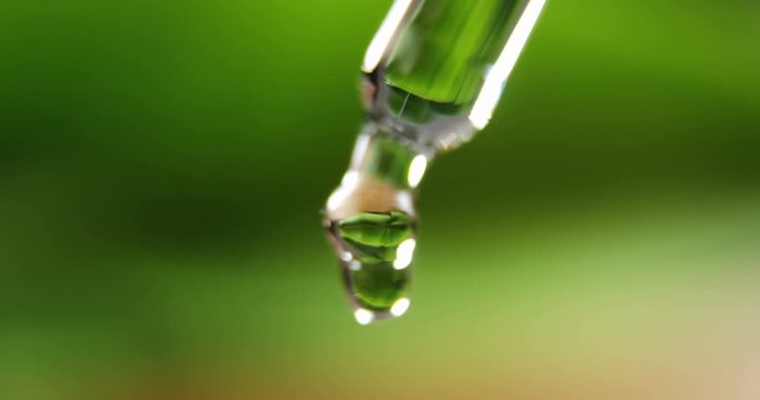 Close-up of dropper with liquid drop 4k